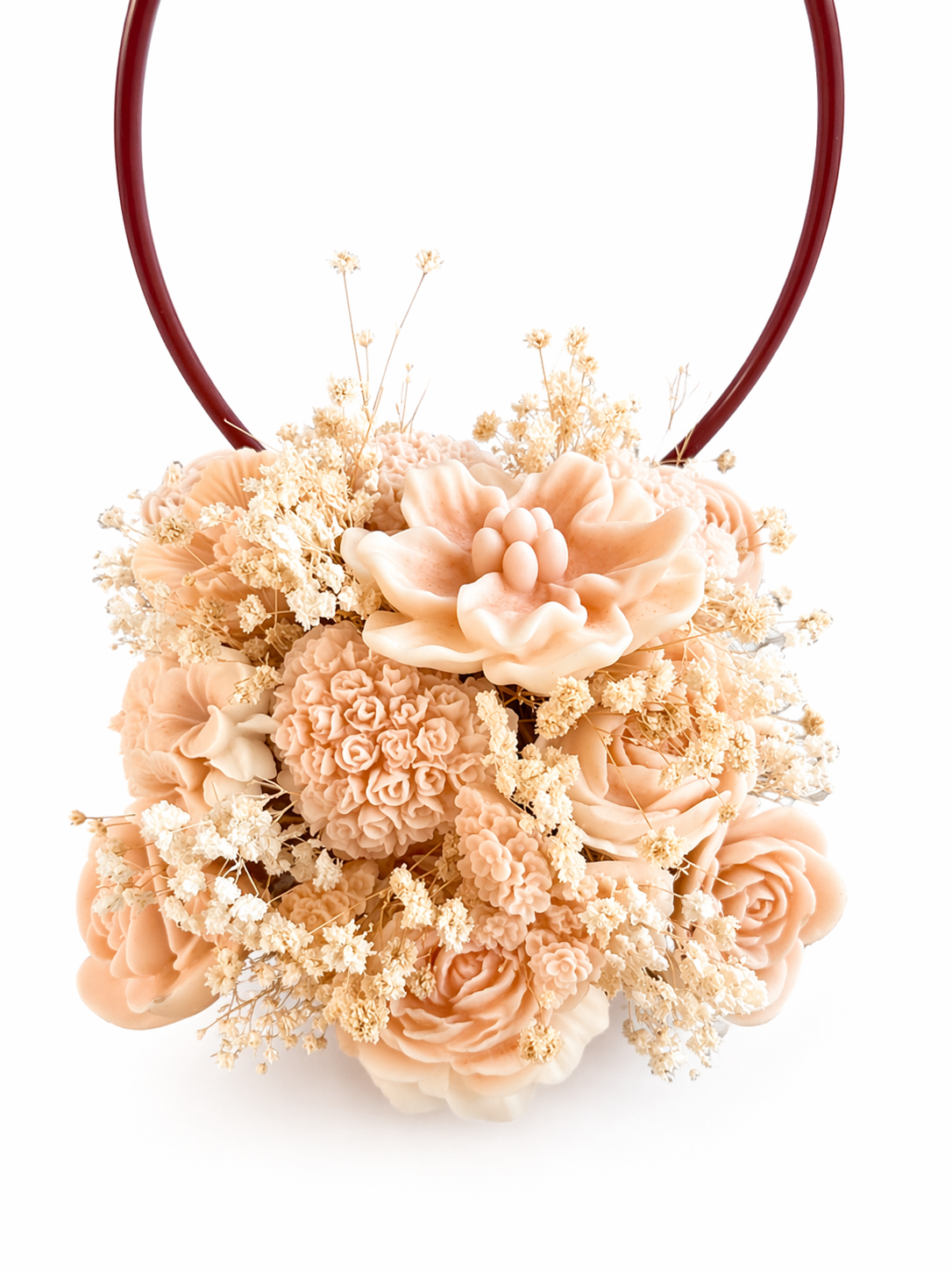 Decorative flower arrangement with peach-colored flowers on a white background