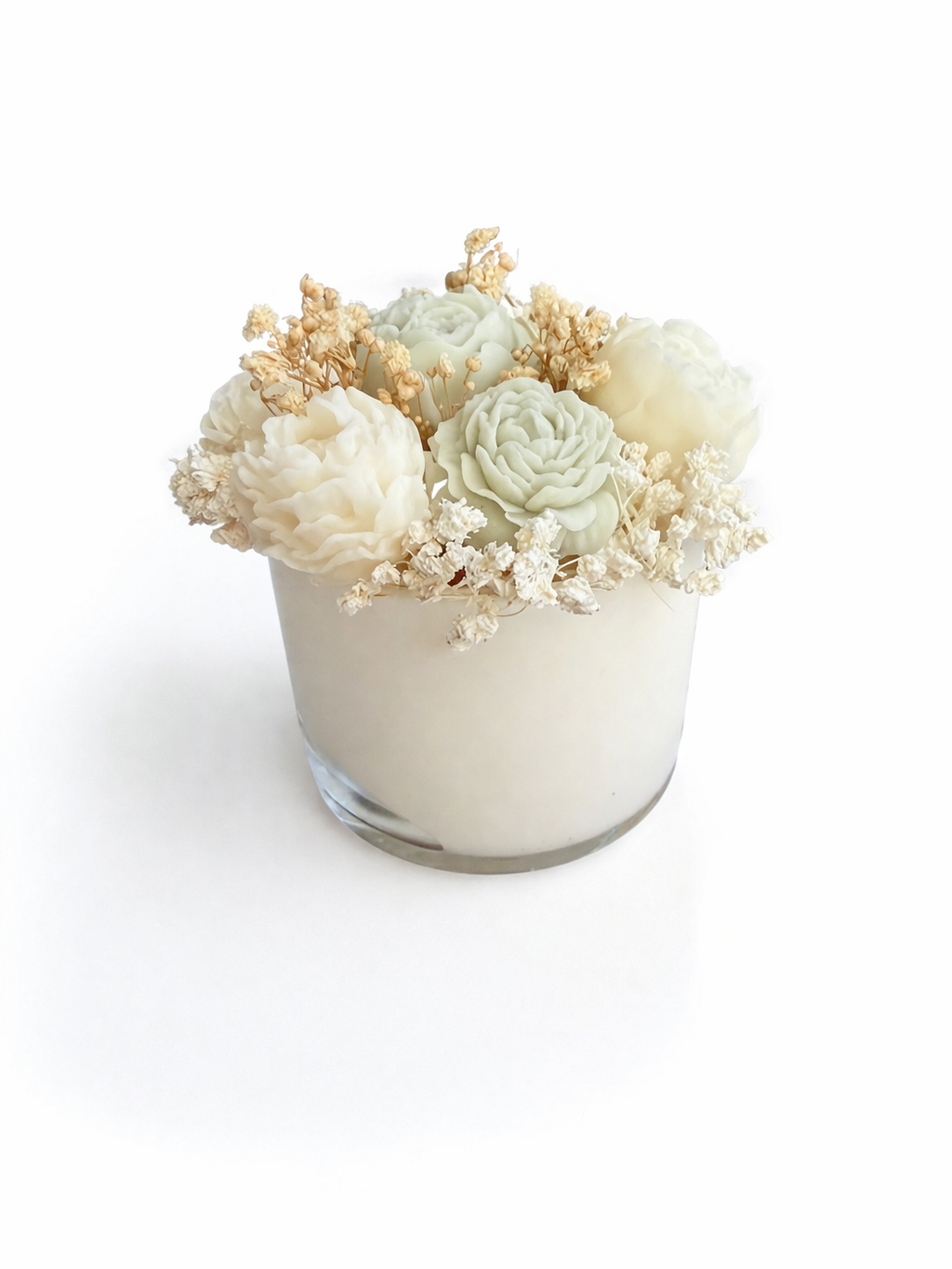 Small glass vase with a arrangement of white and light green flowers on a white background