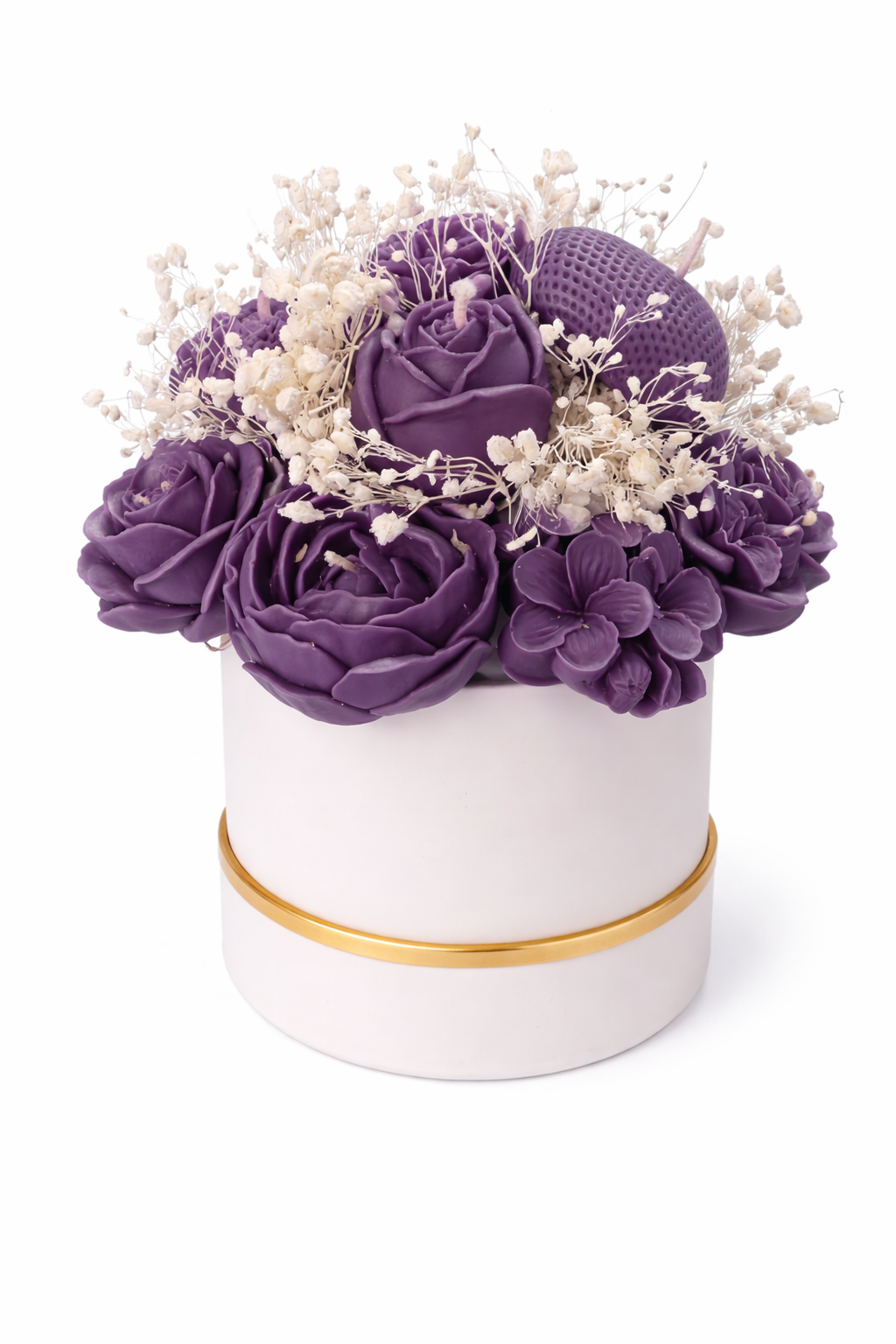 White cylindrical container with gold rim filled with purple and white flowers on a white background