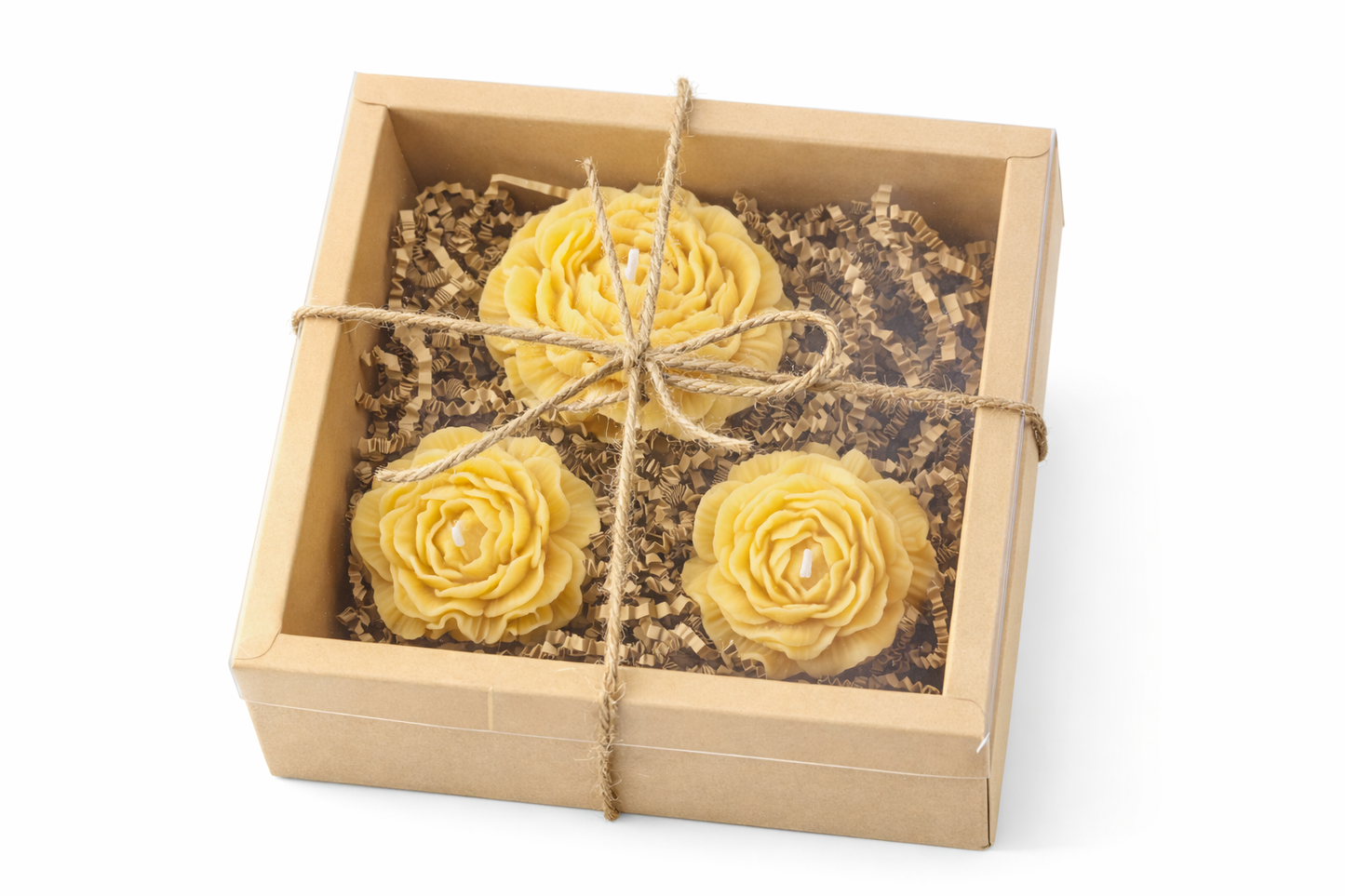 Three yellow flowers in a wooden box with twine on a white background