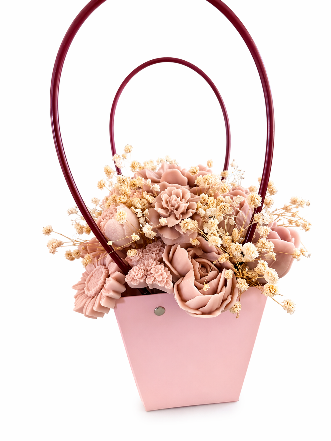 Pink floral arrangement in a basket on a white background