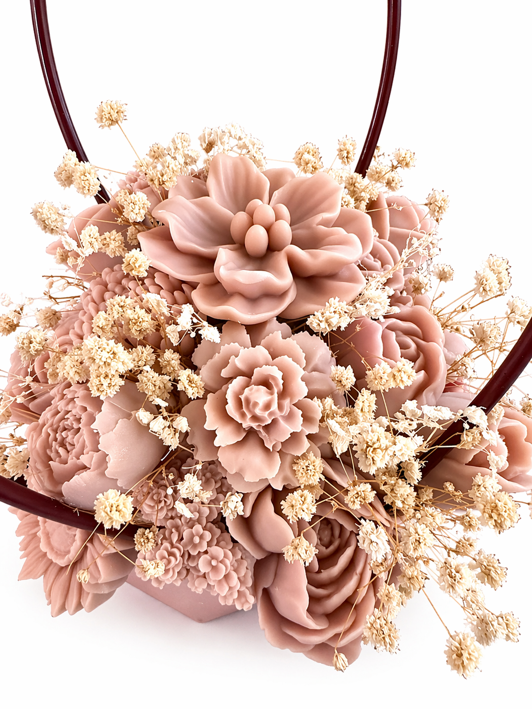 Decorative flower arrangement with pink and beige flowers on a white background