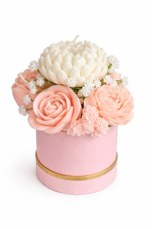 Candle Bouquet (Wick) displaying handcrafted soy wax flowers in soft peach and white hues inside a pink round box with gold trim