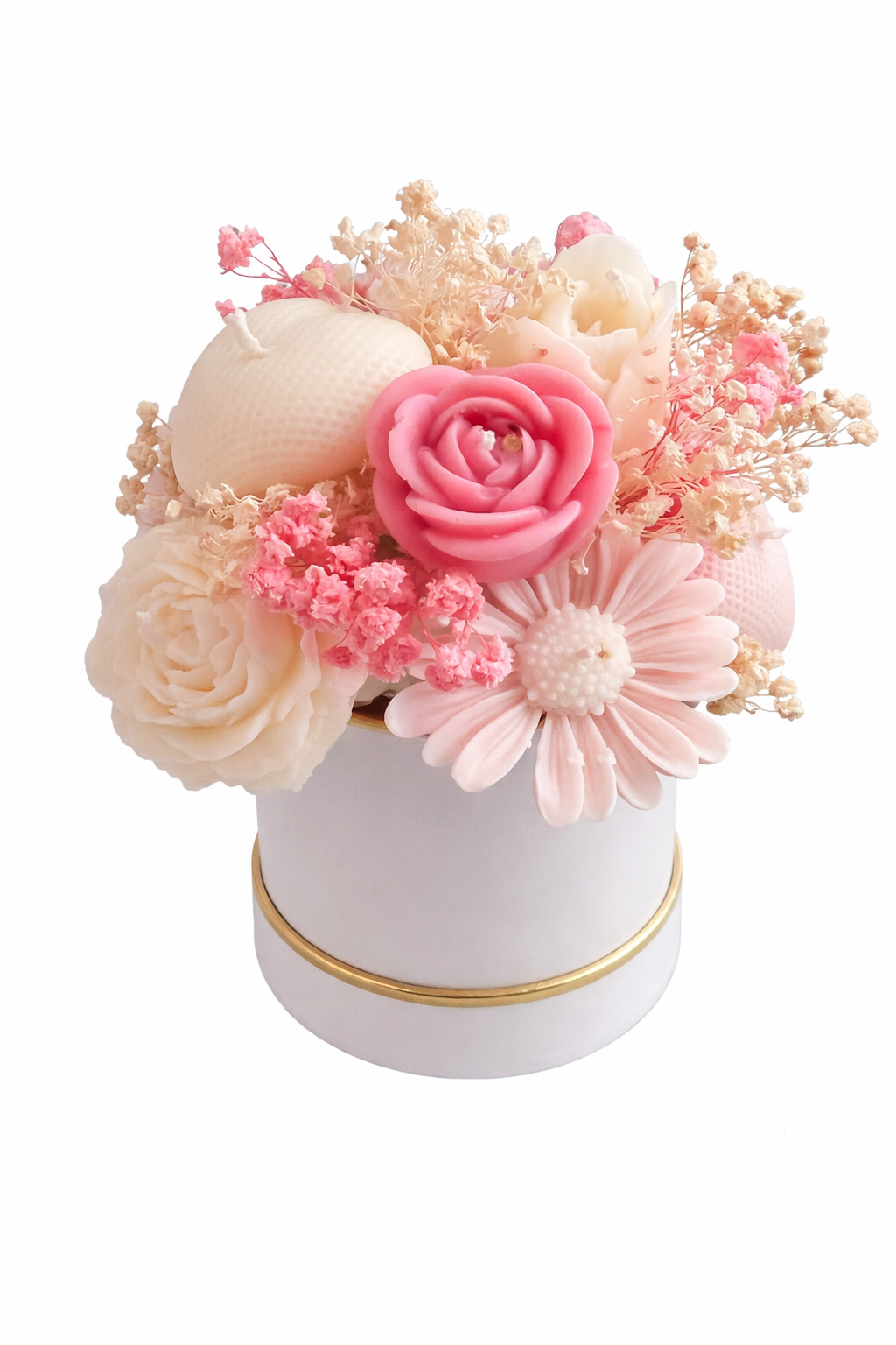 Decorative flower arrangement in a white container with gold rim on a white background