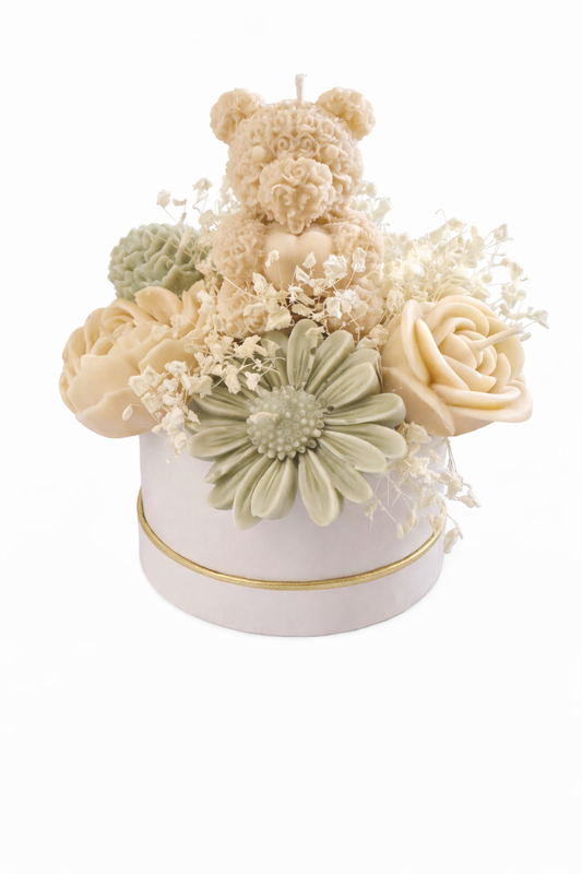 Elegant candle bouquet featuring nine floral candles and a teddy bear centerpiece. Hand-poured and arranged in a luxury box with a 4x4 base — perfect for gifting or décor.