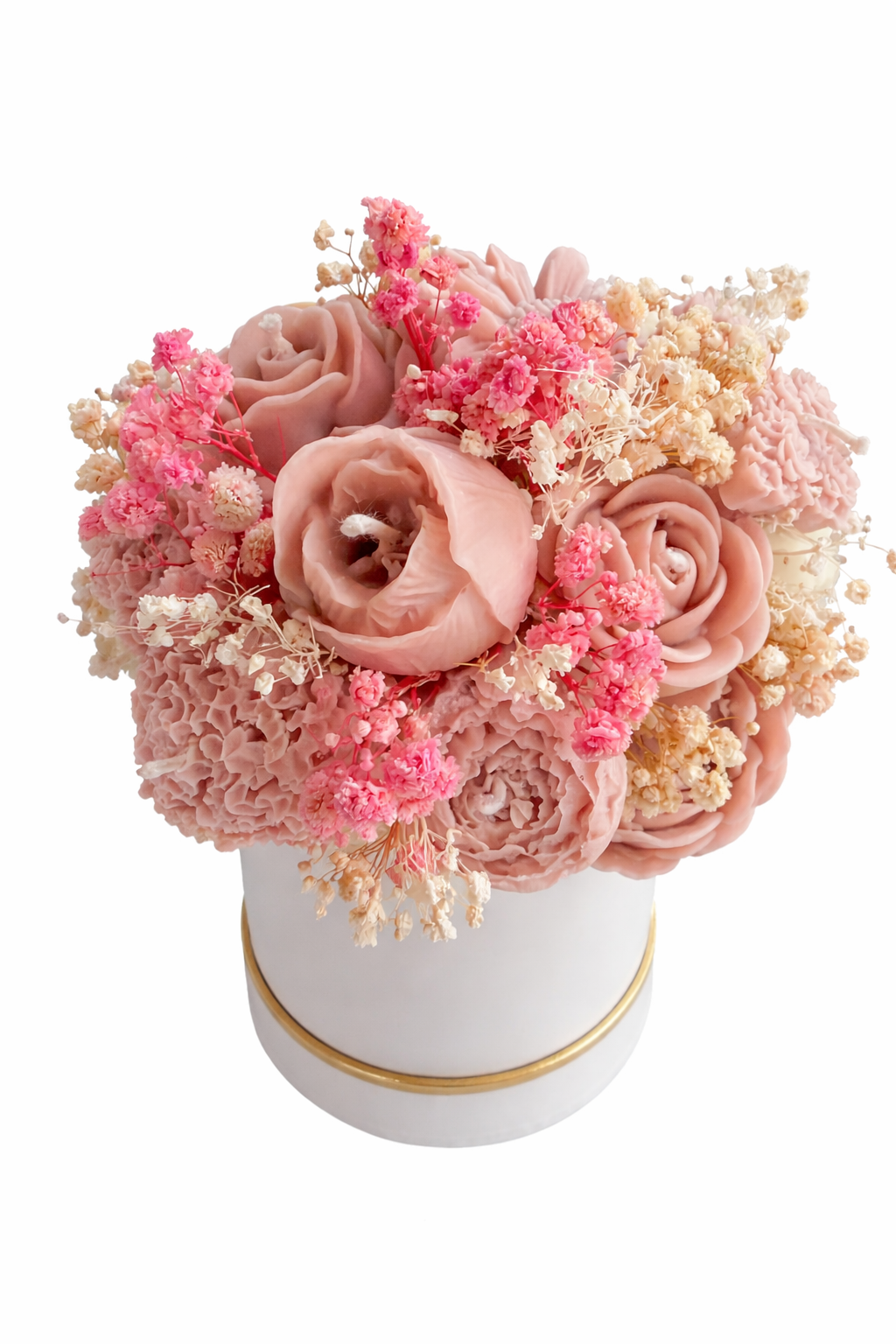 Pink and white floral arrangement in a white container with gold rim on a white background
