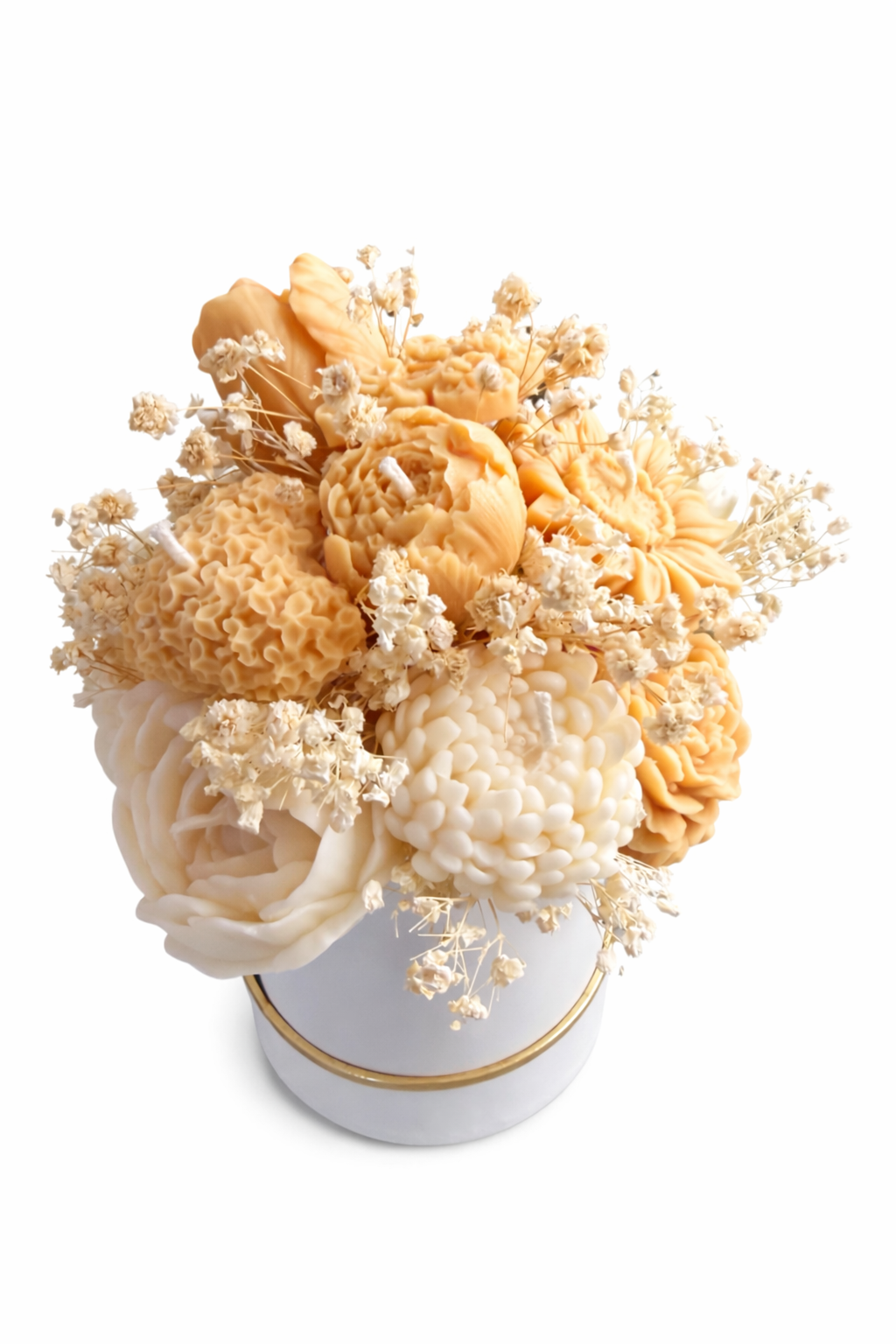 Bouquet of dried flowers in a white container with gold rim on a white background
